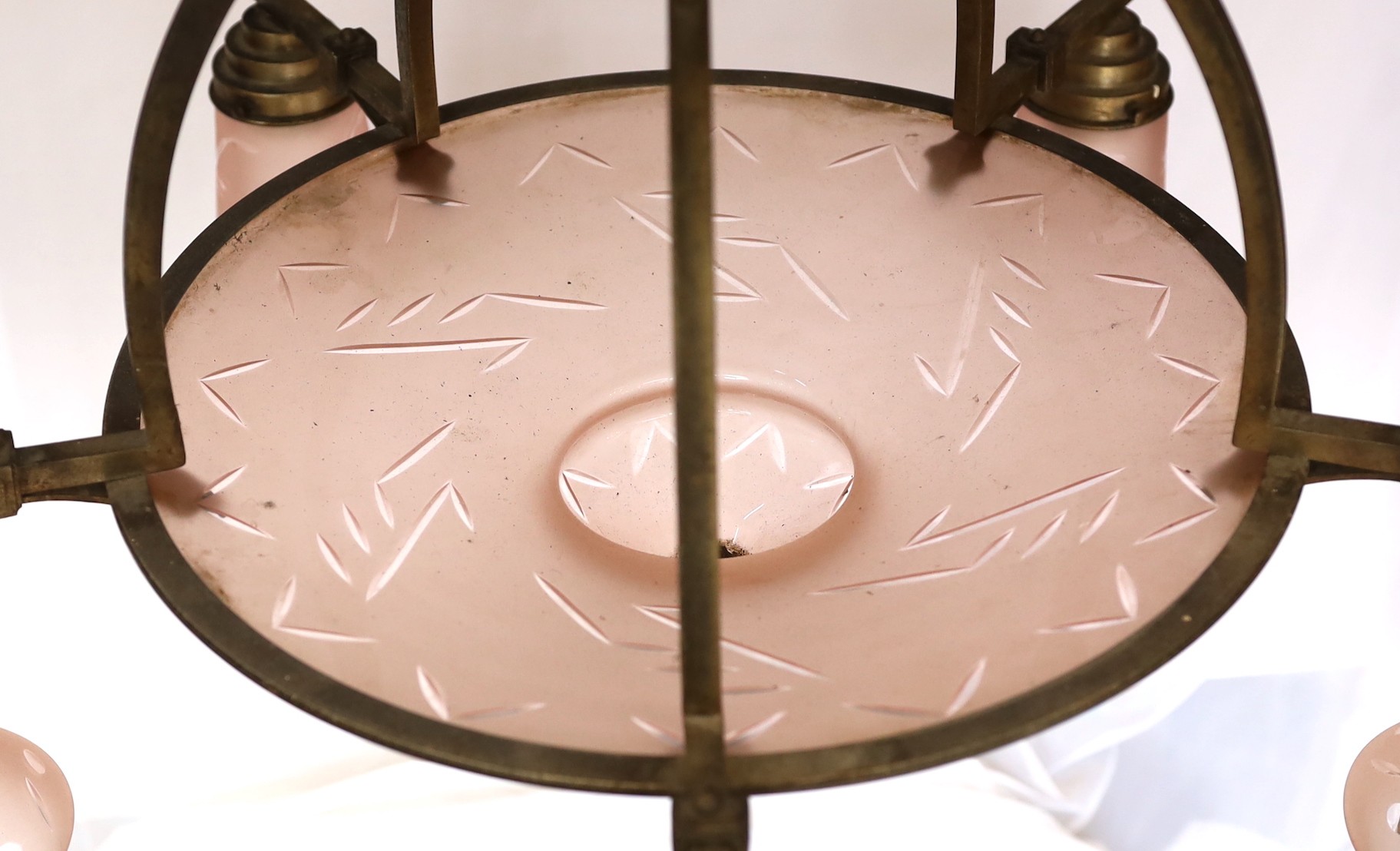 A 1920s-30s German bronze and frosted peach glass five light chandelier of stylish design with geometric cut decoration, drop 75cm. width 70cm
